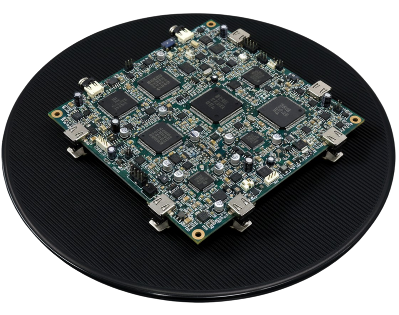 Angled view of a PCB assembly on the D380 ESD turntable; 380 mm (15 in) conductive rubber disc, 200 lb (91 kg) capacity, no power or air